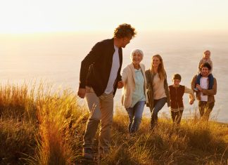 a family hiking up a hill together from the direct primary care website