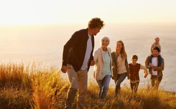 a family hiking up a hill together from the direct primary care website