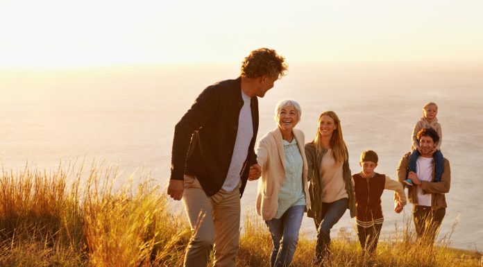 a family hiking up a hill together from the direct primary care website