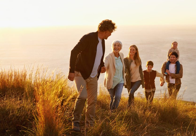 a family hiking up a hill together from the direct primary care website