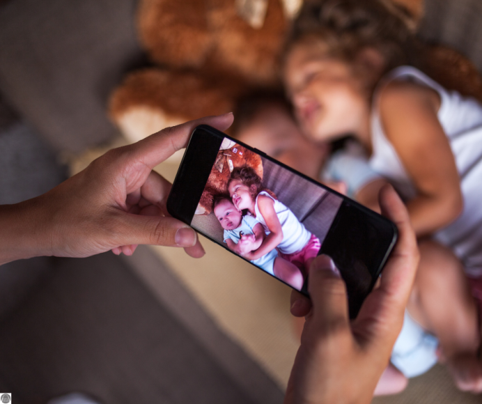 a close up of a mom's iPhone as she takes a picture of her sleeping kids