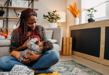 a Black woman breastfeeding her baby