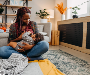 a Black woman breastfeeding her baby 