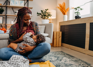 a Black woman breastfeeding her baby