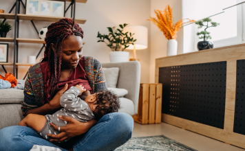 a Black woman breastfeeding her baby