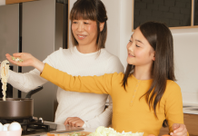 an Asian mom and her daughter cooking ramen together