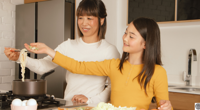 an Asian mom and her daughter cooking ramen together