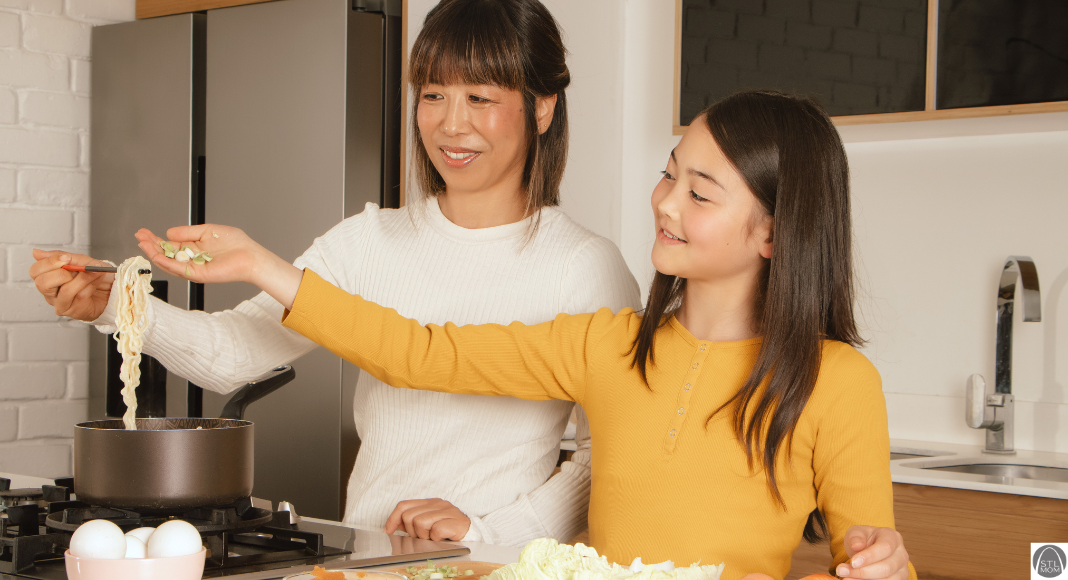 an Asian mom and her daughter cooking ramen together