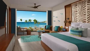 a tropical family-friendly resorts location showcasing a hotel room overlooking the ocean