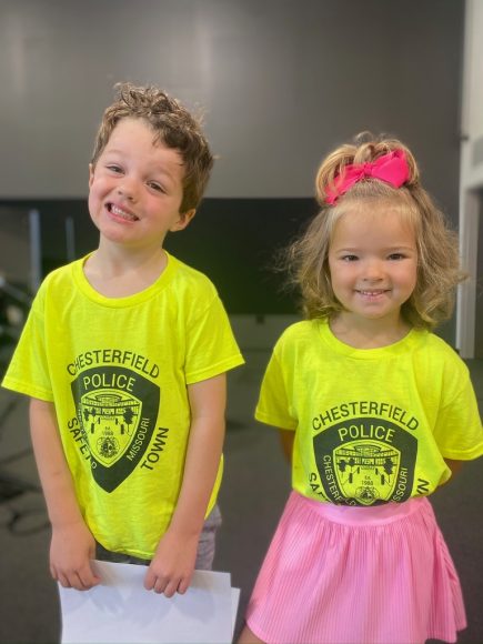 a little boy and his sister in neon yellow shirts as they participate in safety events in St. Louis