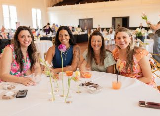 Flourish 2025: A Day to Celebrate Motherhood Event Recap four moms sitting at a table at St. Louis Mom's Flourish 2025 event for motherhood