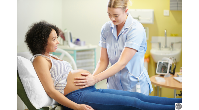 a midwife with her hands on a pregnant woman's belly