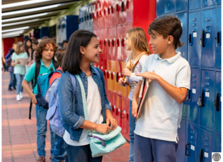 7 Things I Learned From Letting My 7th Grader Date a middle school aged girl and boy talking at school by their lockers