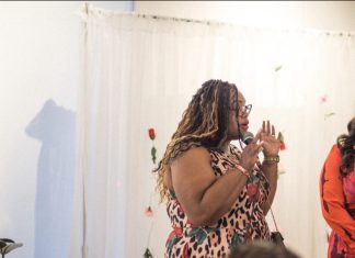 Is It Really Supposed to Be This Hard? an African American woman using a microphone as she is speaking to a group