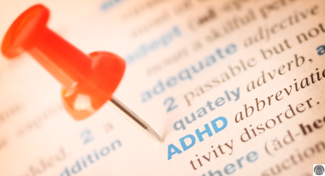a dictionary page with words and definitions, and the word ADHD has a push pin next to it to highlight it
