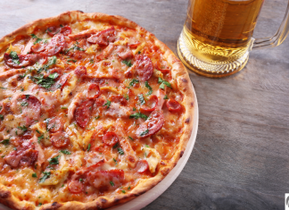 Let’s Celebrate International Beer and Pizza Day in STL a close up of a pizza next to a stein of beer