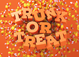 Mom’s Guide to Trunk-or-Treat Orange letters spelling out Trunk or Treat on a candy corn background