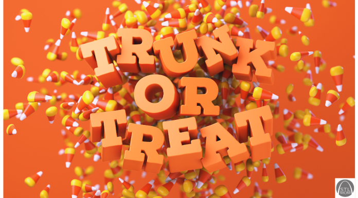 Mom’s Guide to Trunk-or-Treat Orange letters spelling out Trunk or Treat on a candy corn background