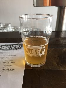 A Good News beer placed next to their menu.