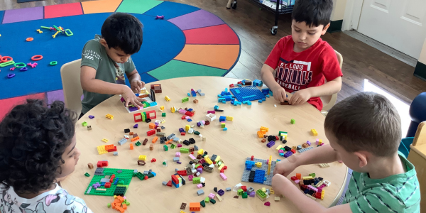 children fostering connection as they play Legos together