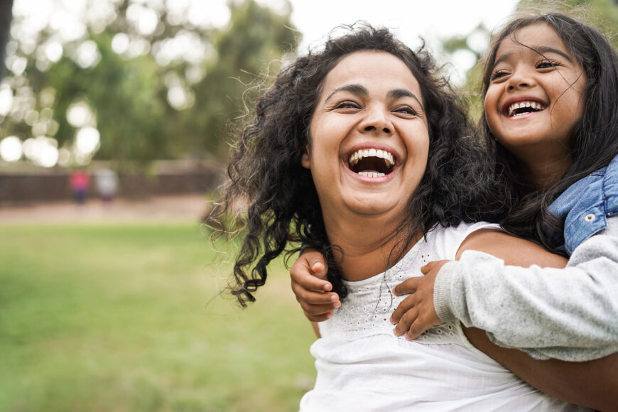 Happy indian mother having fun with her daughter outdoor - Family and love concept - Focus on mom face